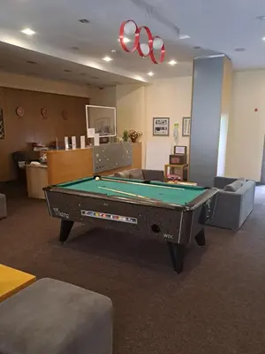a living room with a pool table in a room at Family Studio 302, Villa park in Borovets