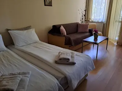 a bedroom with a bed and a chair and a table at Family Studio 302, Villa park in Borovets