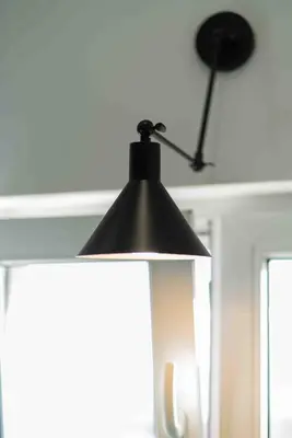 a black lamp hanging from a ceiling at Heart of the City Center Lux Apartment with View in Sofia