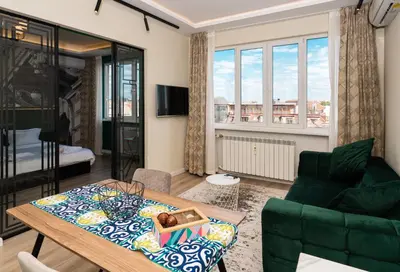 a living room with a table and a couch at Heart of the City Center Lux Apartment2 with View in Sofia