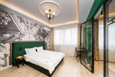 a bedroom with a bed with a green headboard at Heart of the City Center Lux Apartment2 with View in Sofia