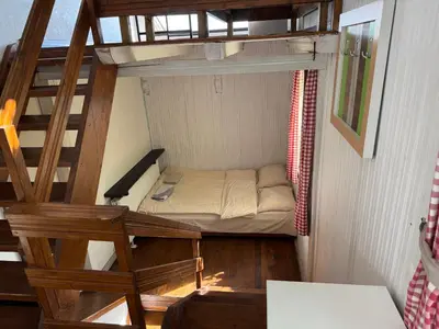 a small room with a bunk bed and a staircase at Александрова вила 1 in Zlatograd
