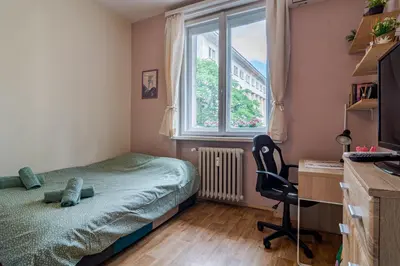 a bedroom with a bed and a desk and a window at The Top Spot - Cute Little Studio in the Center by Flat Mаnager in Sofia