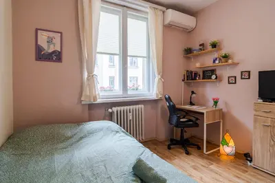 a bedroom with a bed and a desk and a window at The Top Spot - Cute Little Studio in the Center by Flat Mаnager in Sofia