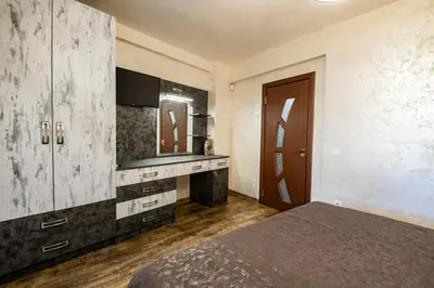 a bedroom with a bed and a vanity and a mirror at Luxe Apartment Grand Monastery in Pamporovo in Pamporovo