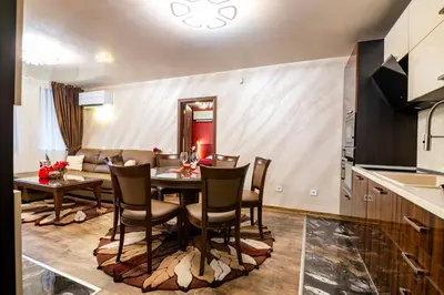 a kitchen and dining room with a table and chairs at Luxe Apartment Grand Monastery in Pamporovo in Pamporovo