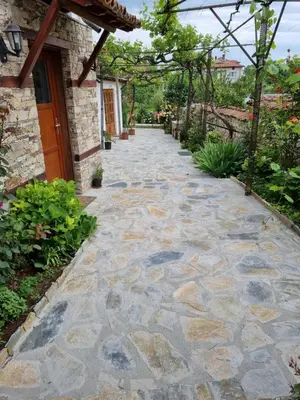 a stone walkway in front of a house at Walnut Cottage 1 in Deredzhik-Kʼoy