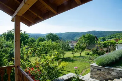 a view of a garden from the porch of a house at Walnut Cottage 1 in Deredzhik-Kʼoy