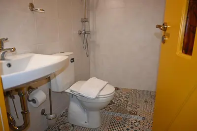 a bathroom with a toilet and a sink at Villa Magicland in Sofia