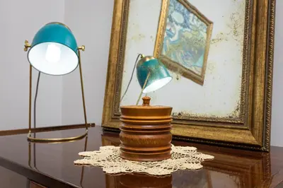 a table with a lamp and a lampost and a picture at The Old Town Vintage 2-Bedroom Jewel by Flat Mаnager in Plovdiv