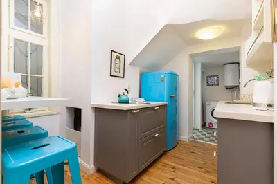 a kitchen with a blue cabinet and blue stools at The Old Town Vintage 2-Bedroom Jewel by Flat Mаnager in Plovdiv