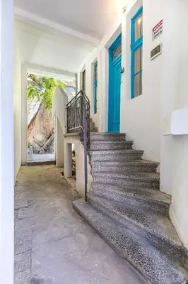 a staircase in a building with a blue door at The Old Town Vintage 2-Bedroom Jewel by Flat Mаnager in Plovdiv