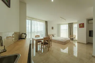 a large living room with a table and a couch at апартаменти Пасажио in Sandanski