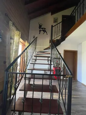 a staircase in a house with a stair case at Pirin Golf Penthouse Iliyana in Bansko