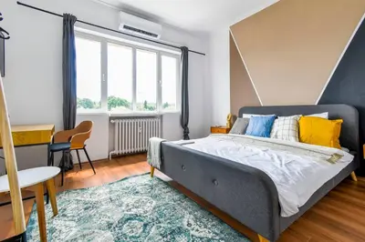 a bedroom with a large bed and a table at 3 Rooms Together Budget Central Stay in Sofia