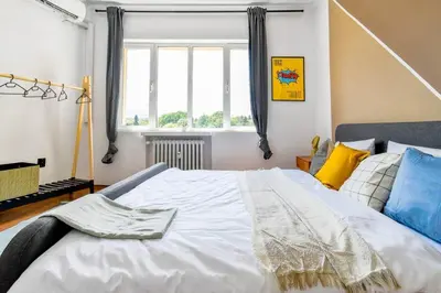 a large white bed in a room with a window at 3 Rooms Together Budget Central Stay in Sofia