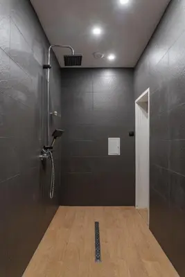a bathroom with a shower with a shower head at Luxury Apart Vitosha Boulevard in Sofia