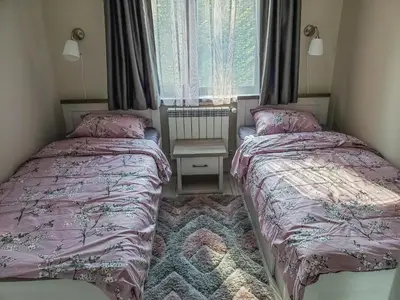 a bedroom with two beds and a window at Lovely Borovets Apartment in Borovets