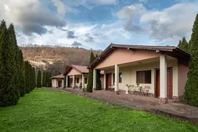 a house with a green lawn in front of it at Вили Тихия Кът in Ribarica