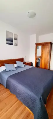a bedroom with a large bed with a blue blanket at Apartment in Belvedere Club G205 in Bansko