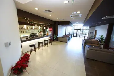 a lobby with a bar in a restaurant with chairs and tables at Aspen Golf Resort Studio I205 in Bansko