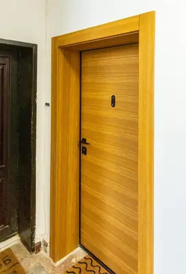 a wooden door in a room with a floor at Sofia Downtown Boutique Apartment in Sofia