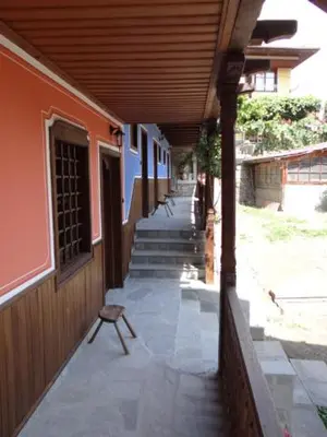 a porch of a building with a bench on it at Недкова къща in Koprivshtitsa