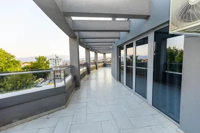 a balcony of a building with a view of a city at Мезонет Пасажио in Sandanski