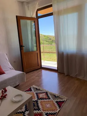 a living room with a door open to a patio at Sunny Home in Sandanski