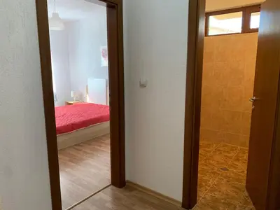 a hallway with a door leading to a bedroom at Sunny Home in Sandanski