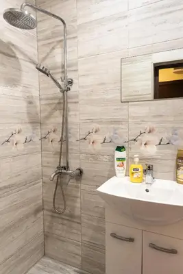 a bathroom with a shower and a white sink at Bendida Park in Velingrad