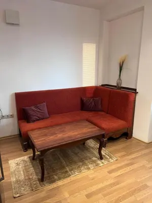 a red couch with two pillows on it in a room at Dalv Residence - SPA Fairy Tale in old Sofia in Sofia