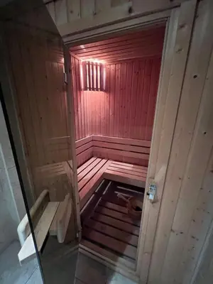 an inside view of a wooden sauna with a red wall at Dalv Residence - SPA Fairy Tale in old Sofia in Sofia