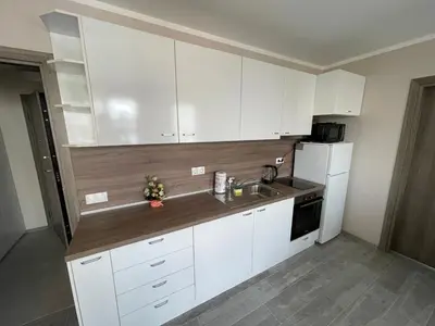 a kitchen with white cabinets and a sink at Movie flats in Sofia
