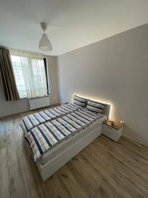 a bedroom with a bed in a white room at Movie flats in Sofia