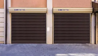two metal garage doors on the side of a building at Peaceful Riverside Studio with private Garden Center Parking in Plovdiv