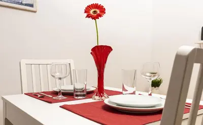a table with a vase with a flower on it at Peaceful Riverside Studio with private Garden Center Parking in Plovdiv