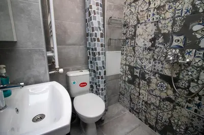 a bathroom with a toilet and a sink and a shower at Mountain View Apartment 1 + Parking in Sofia