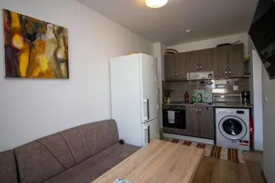 a living room with a couch and a refrigerator at City View Apartment + Parking in Sofia