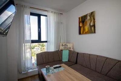 a living room with a couch and a table at City View Apartment + Parking in Sofia