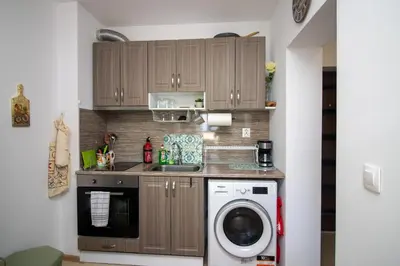 a kitchen with a washer and dryer in a room at City View Apartment + Parking in Sofia