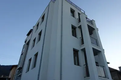 a white building with windows on the side of it at ENIS Hotel със закрит и отоплен минерален басейн in Sapareva Banya