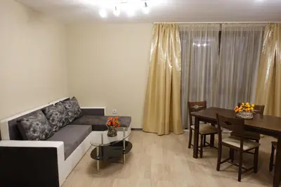 a living room with a couch and a table at ENIS Hotel със закрит и отоплен минерален басейн in Sapareva Banya
