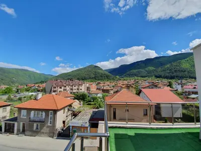 a view of a town with mountains in the background at ENIS Hotel със закрит и отоплен минерален басейн in Sapareva Banya