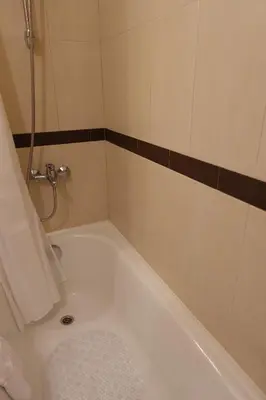 a bathroom with a bath tub with a shower at GO GO Holiday in Borovets