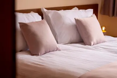 a white bed with white pillows on it at GO GO Holiday in Borovets