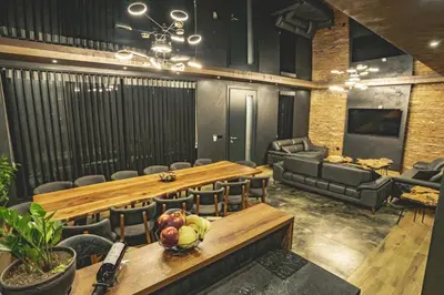 a conference room with a table and chairs and a couch at Вила АМРИТА in Tsigov Chark
