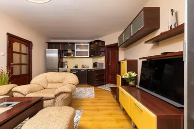 a living room with two chairs and a flat screen tv at Centrally-located 1BD Apartment near Kapana by Flat Mаnager in Plovdiv