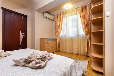 a bedroom with a bed and a window and shelves at Centrally-located 1BD Apartment near Kapana by Flat Mаnager in Plovdiv