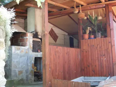 a wooden entrance to a house with a brick oven at Guest House Rimski Most in Melnik